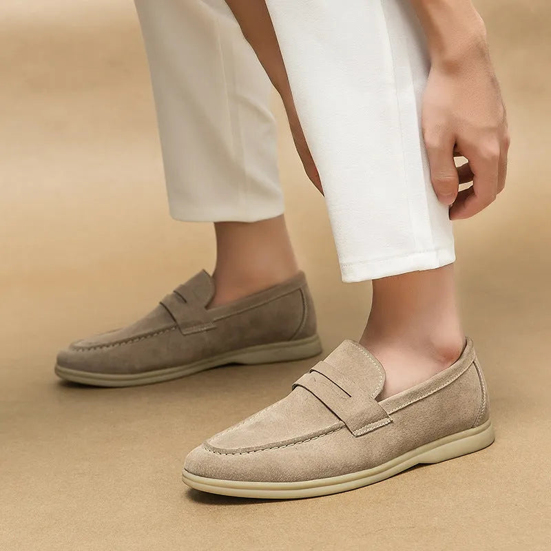 Men's black leather slip-on shoes with round toe and oversleeve design on a rubber sole