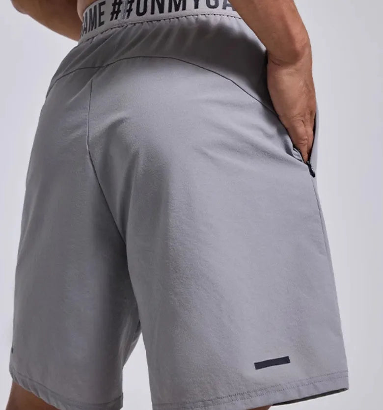 Men's loose grey sports shorts with elastic fly opening and letter detailing for athletic wear