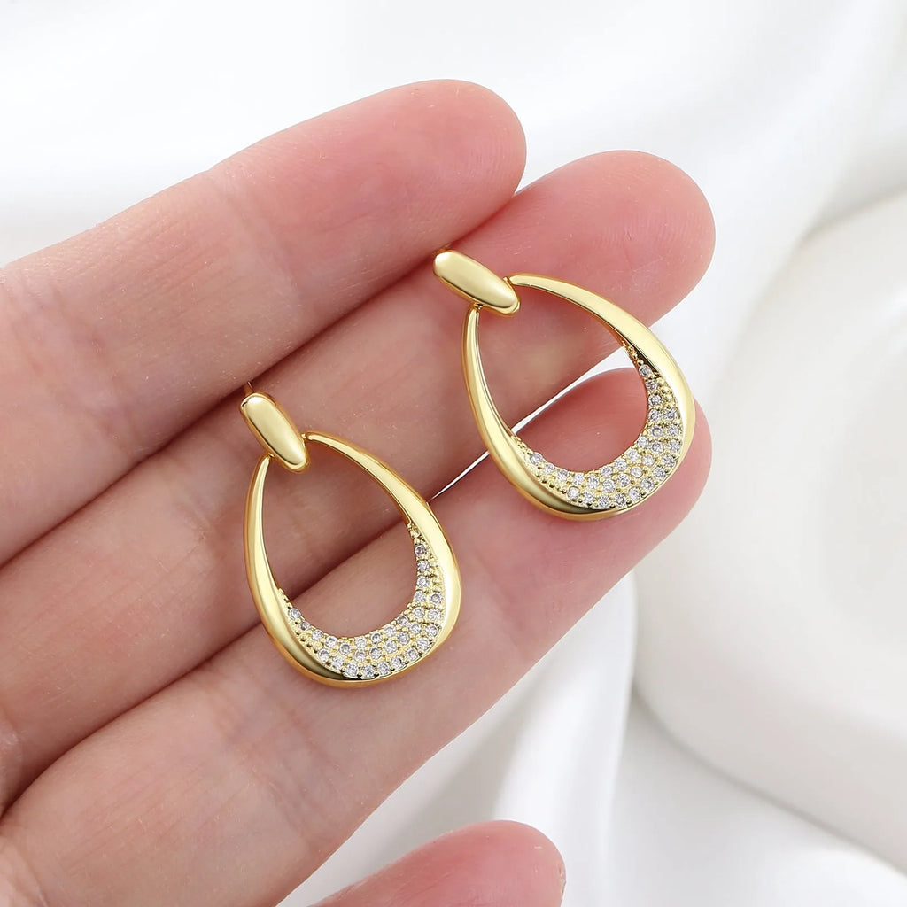 Geometric drop-shaped women's earrings in yellow gold colour with zircon design elements