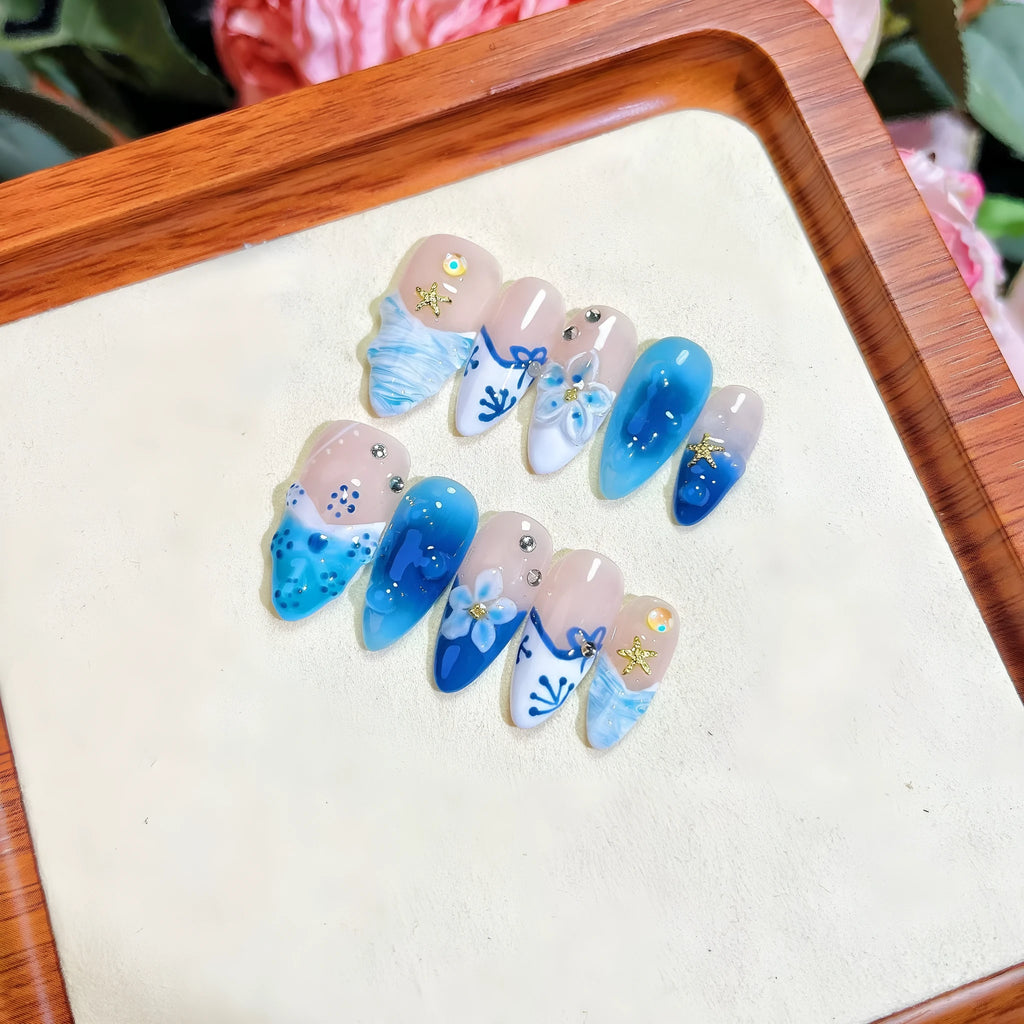 Blue carved transparent fake nails with hand-painted patterns in four sizes