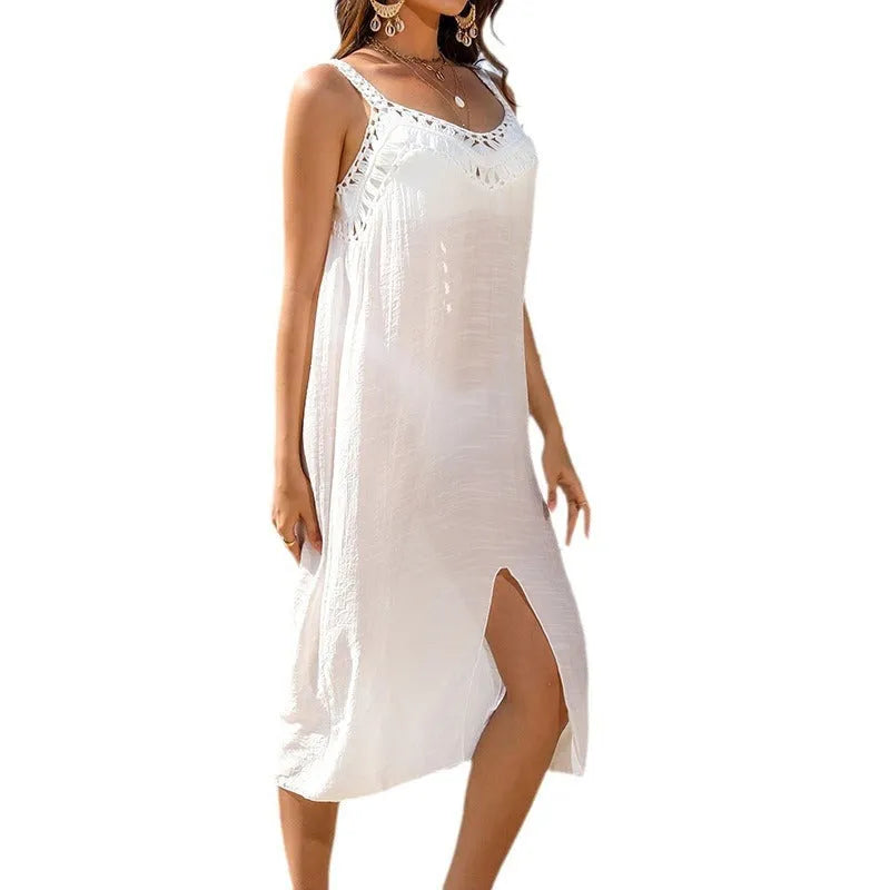 White crochet beach dress with suspenders and bottom slit on mannequin