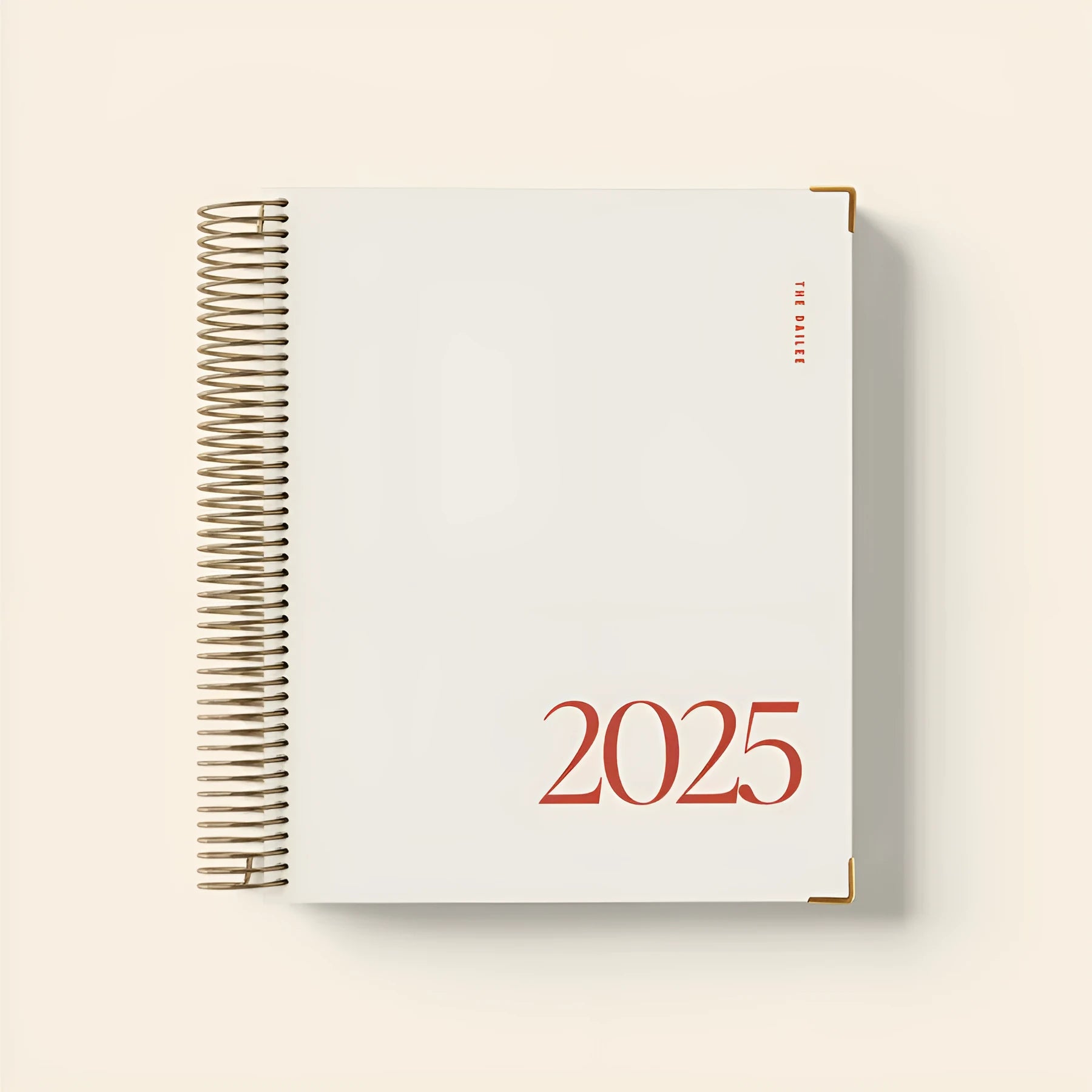 Cherry red A5 coil notebook open showing daily schedule pages and wire-o binding