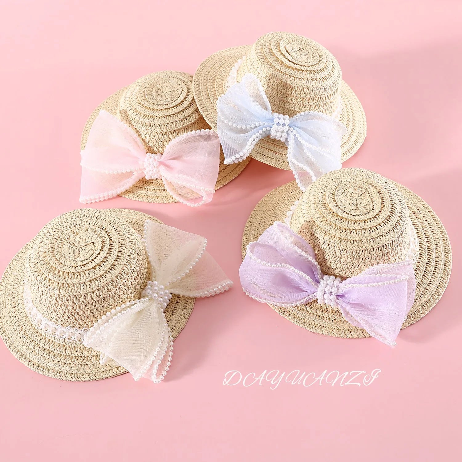Pink pearl butterfly bow woven straw hat for a cat on a mannequin head.