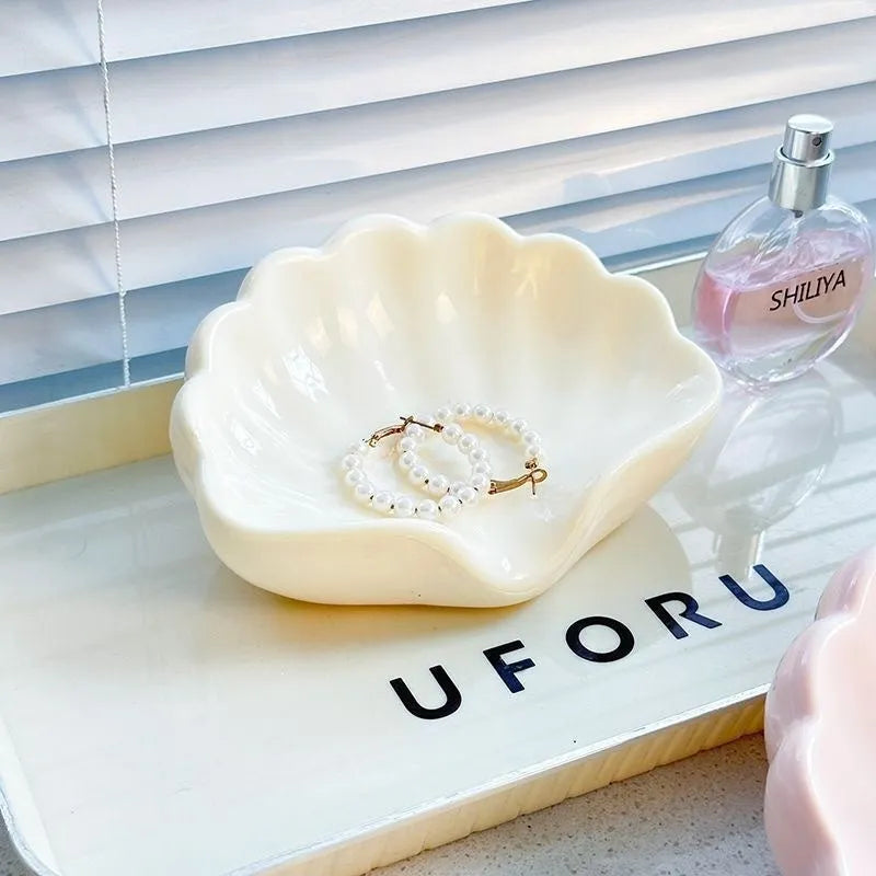 Plastic shell-shaped soap dish in pearl white or cherry blossom pink for bathroom organisation