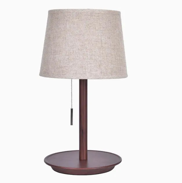 Walnut colour solid wood desk lamp with a white cloth shade and black cable switch.