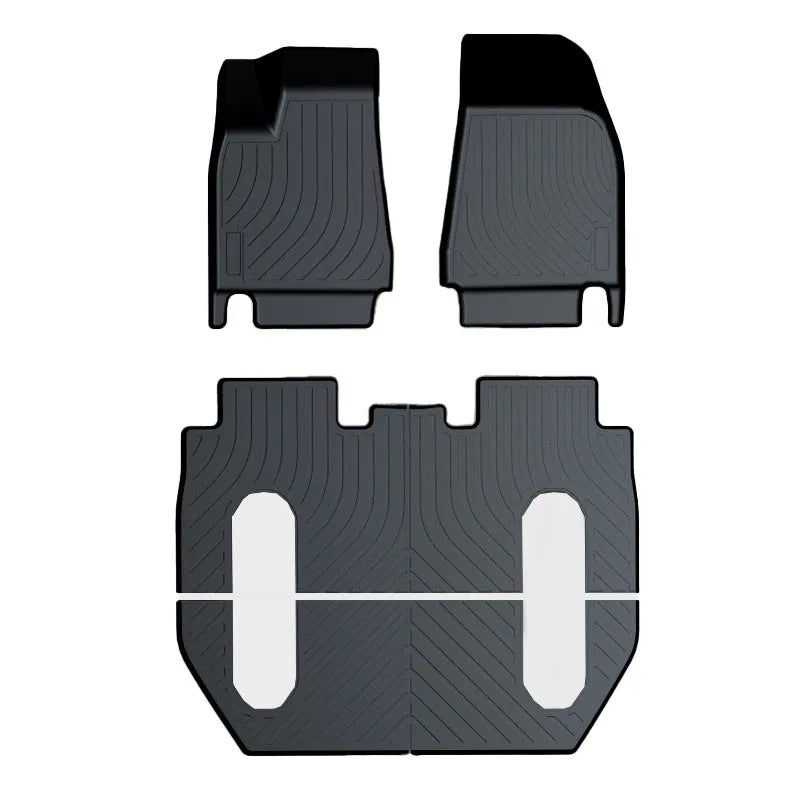 Black rubber floor mat for Tesla car interior with textured TPE footrest section.