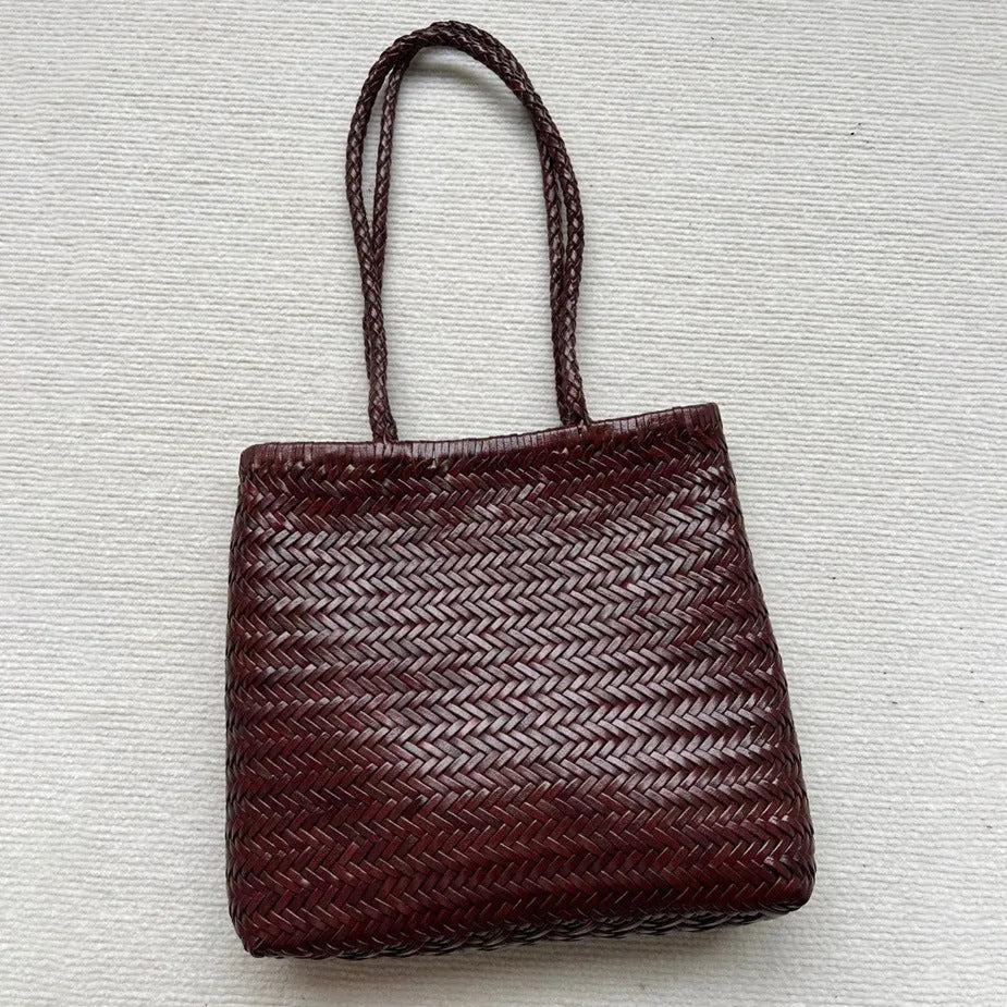 Brown handmade woven leather tote bag with three-dimensional pocket showing vintage texture