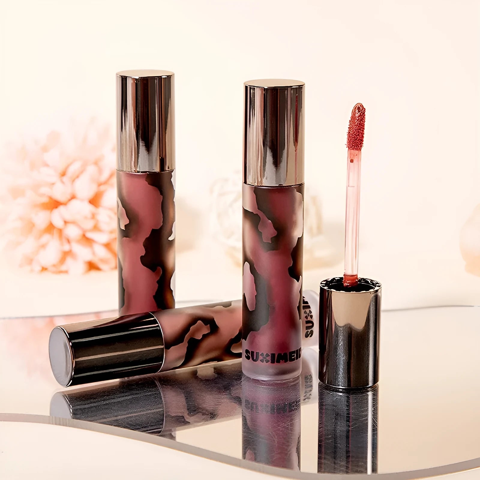 Matte liquid lipstick tube showing five colour options including orange brown coffee and jujube red