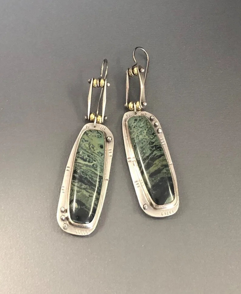 Geometric alloy earrings with two-colour marble pattern, showing angular shape and blended colour effect