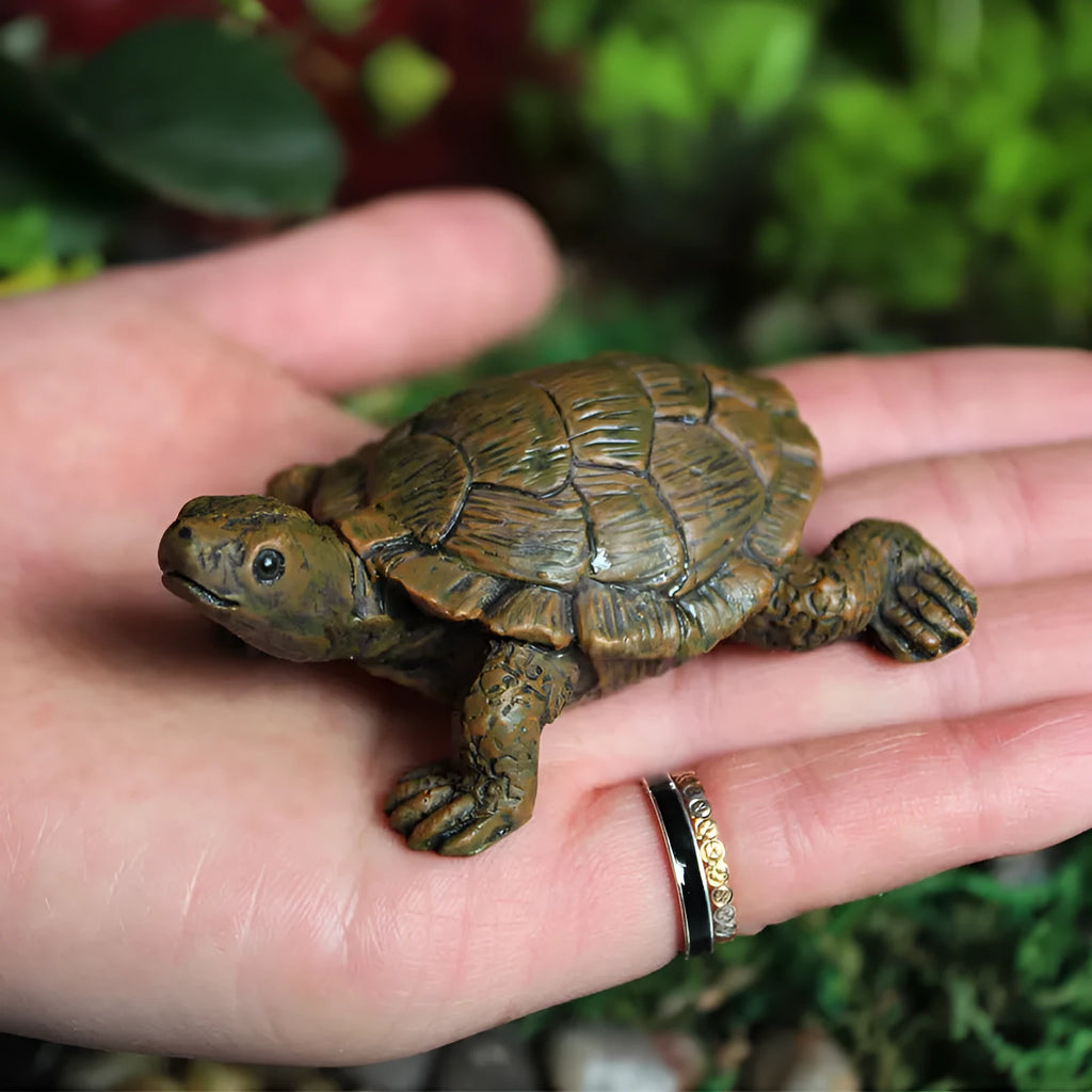 Small resin simulation turtle ornament for miniature garden and terrarium decoration.