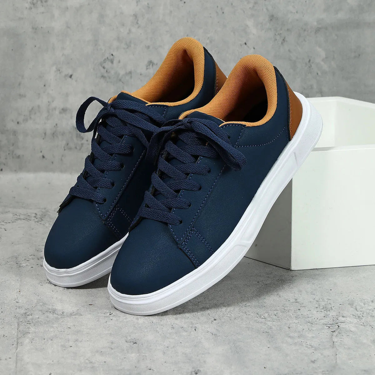 Beige brown casual platform sneakers with cross strap detail and rubber sole.