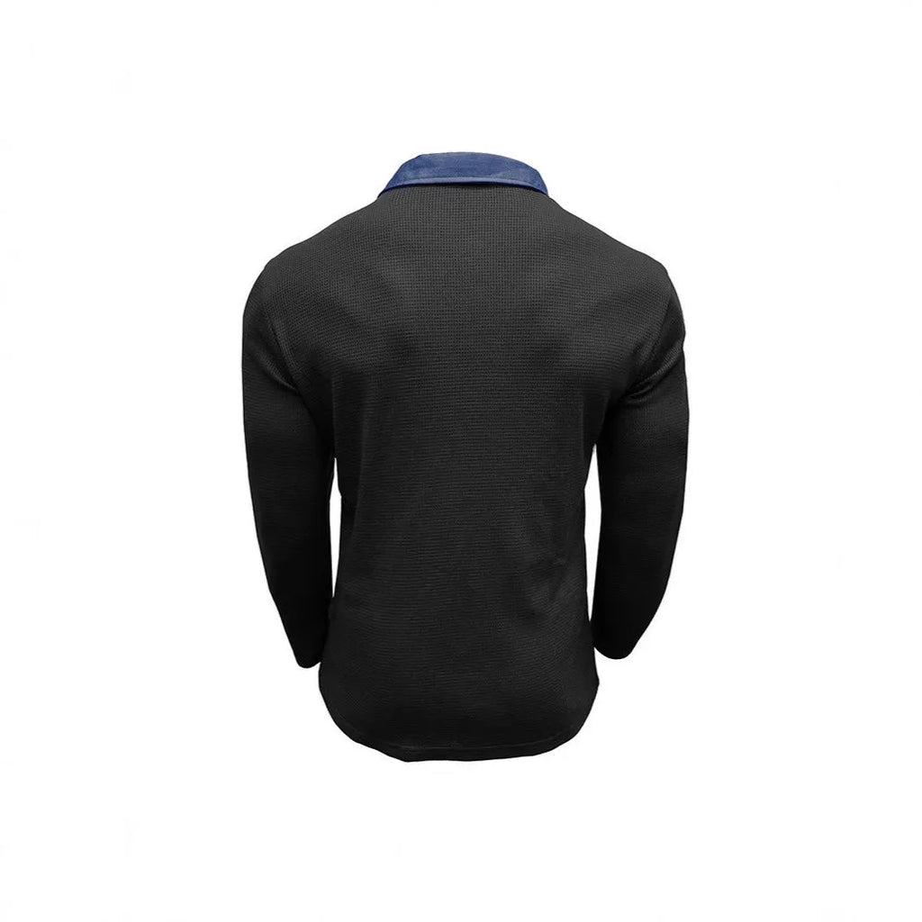 Man wearing a long-sleeved waffle-textured polo shirt in a dark colour with an asymmetric design detail.