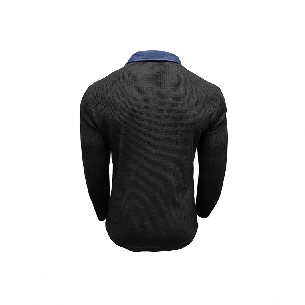 Man wearing a long-sleeved waffle-textured polo shirt in a dark colour with an asymmetric design detail.