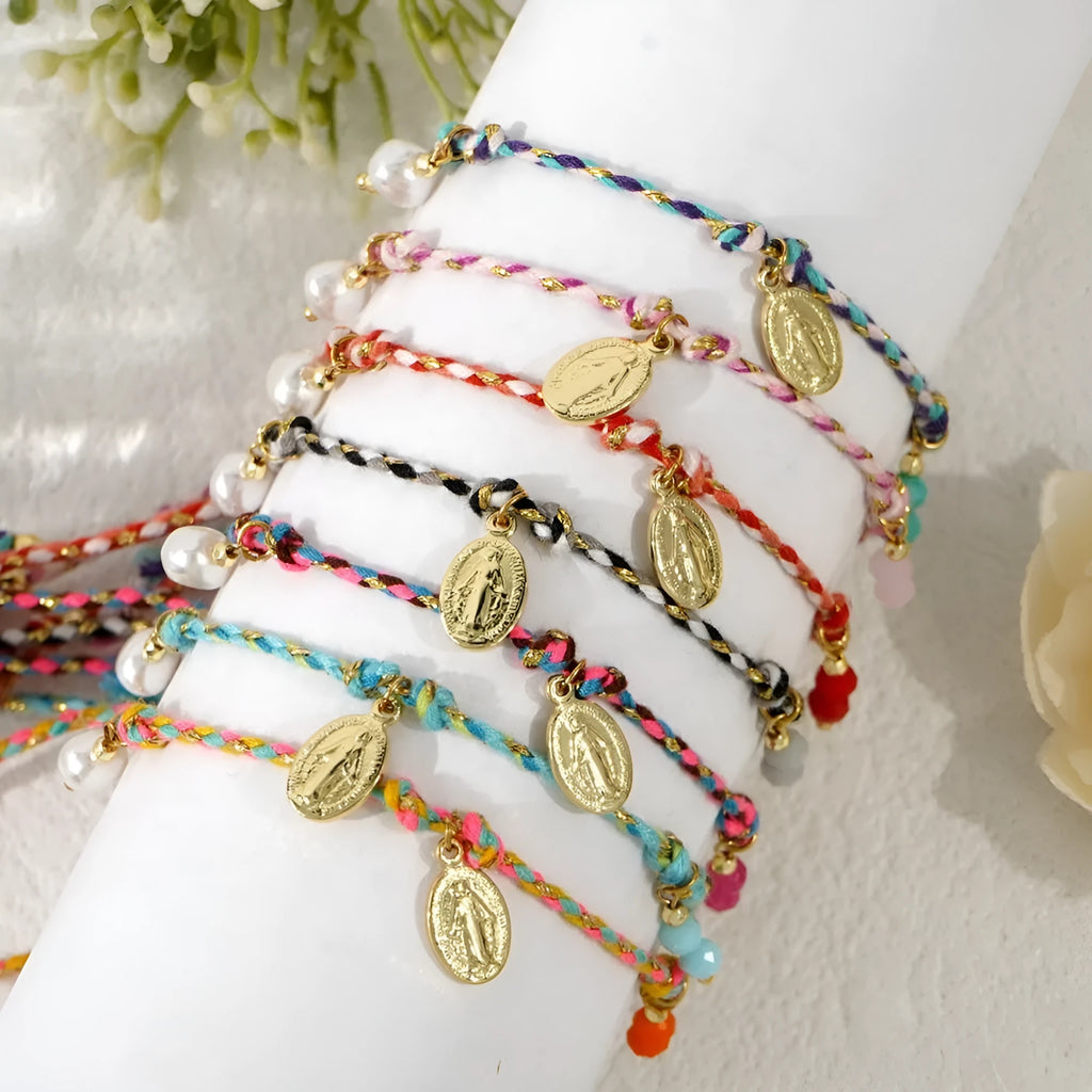 Ethnic style hand-woven bracelet made from colourful braided rope on woman's wrist