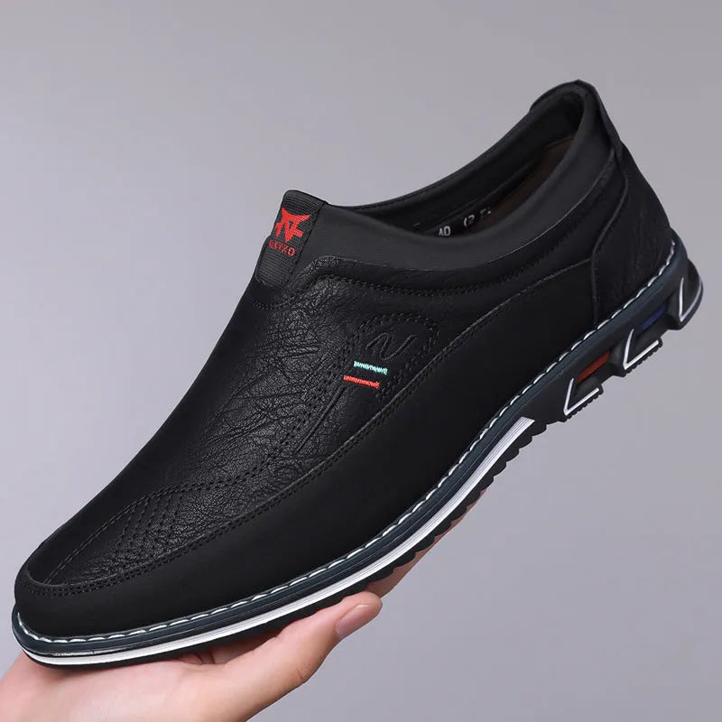 Men's black leather toe cap casual shoes with a rubber sole and sewing line detail on the fabric upper.