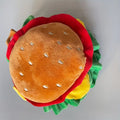 Cat wearing a soft faux leather burger headdress collar with an adjustable strap.