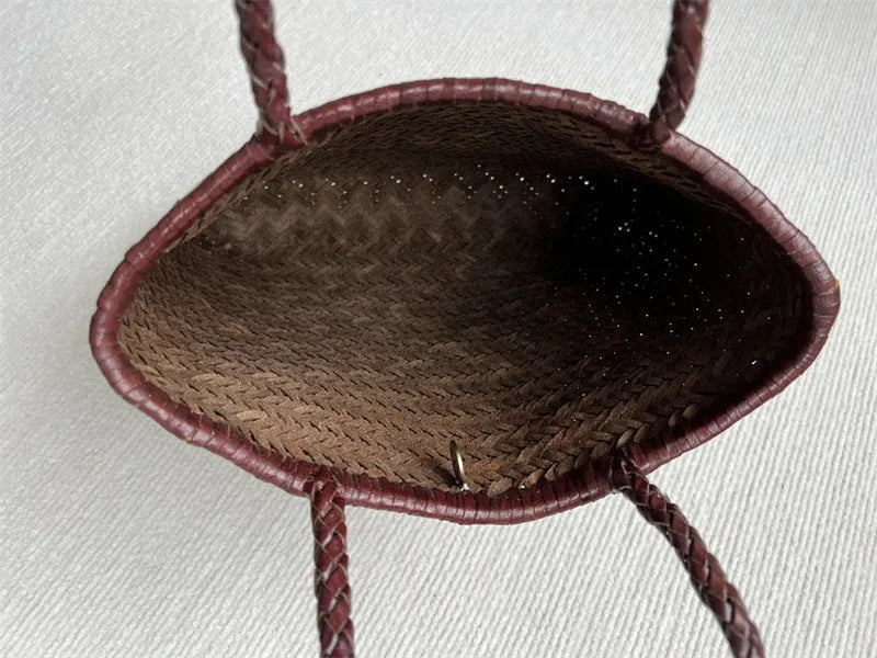 Brown handmade woven leather tote bag with three-dimensional pocket showing vintage texture