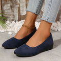 Women's suede wedge pump in light brown with pointed toe and low wedge heel.