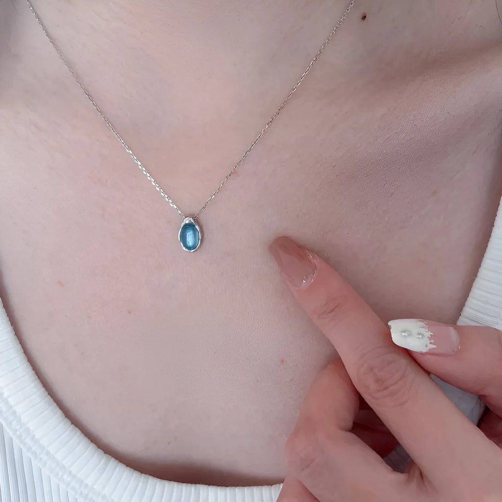 Women's navy blue geometric water drop pendant on an adjustable silver-toned chain.