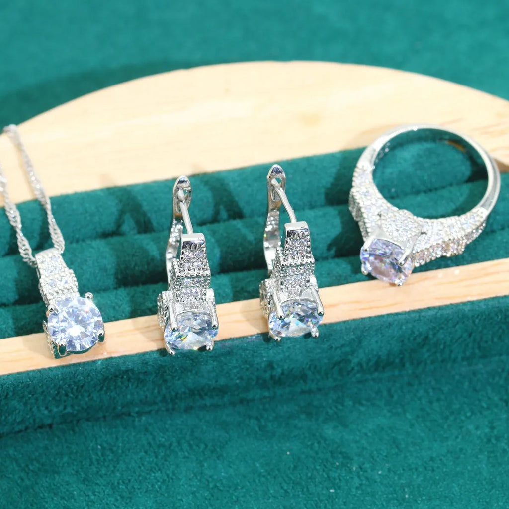 Four-piece bridal jewellery set with zircon alloy necklace, earrings, bracelet, and ring in water wave chain design