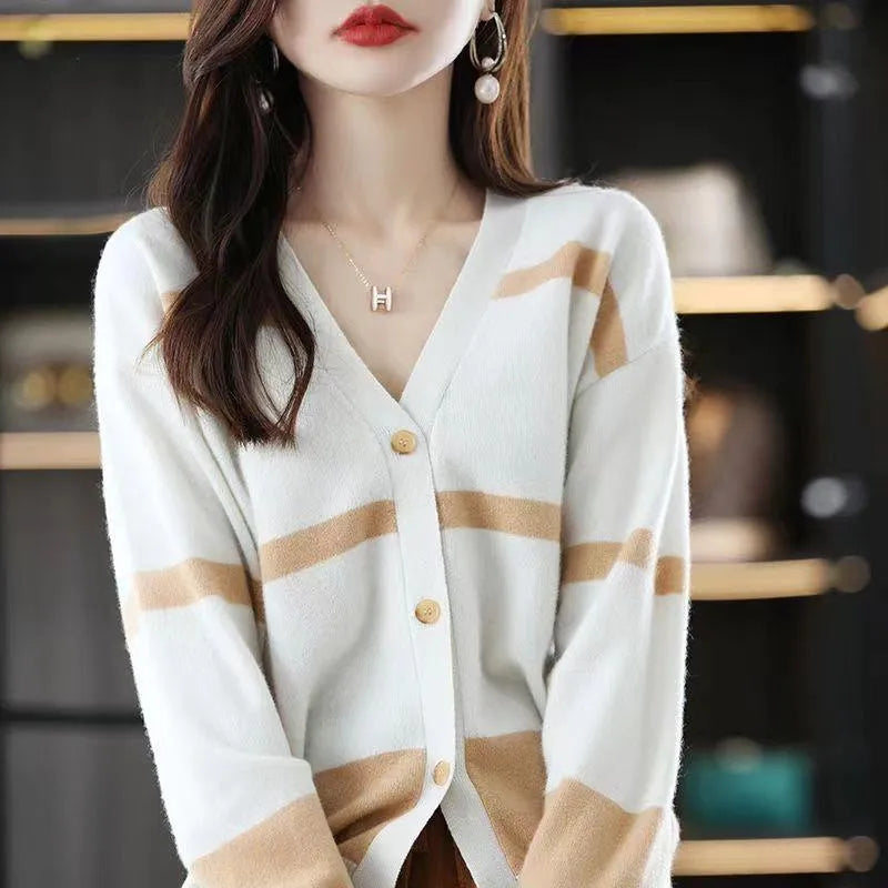 Woman wearing a slim fit V-neck knitted cardigan with a black and white 3D striped pattern