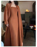 Women's grey knitted cardigan dress and coat suit set with long skirt and flocking detail.