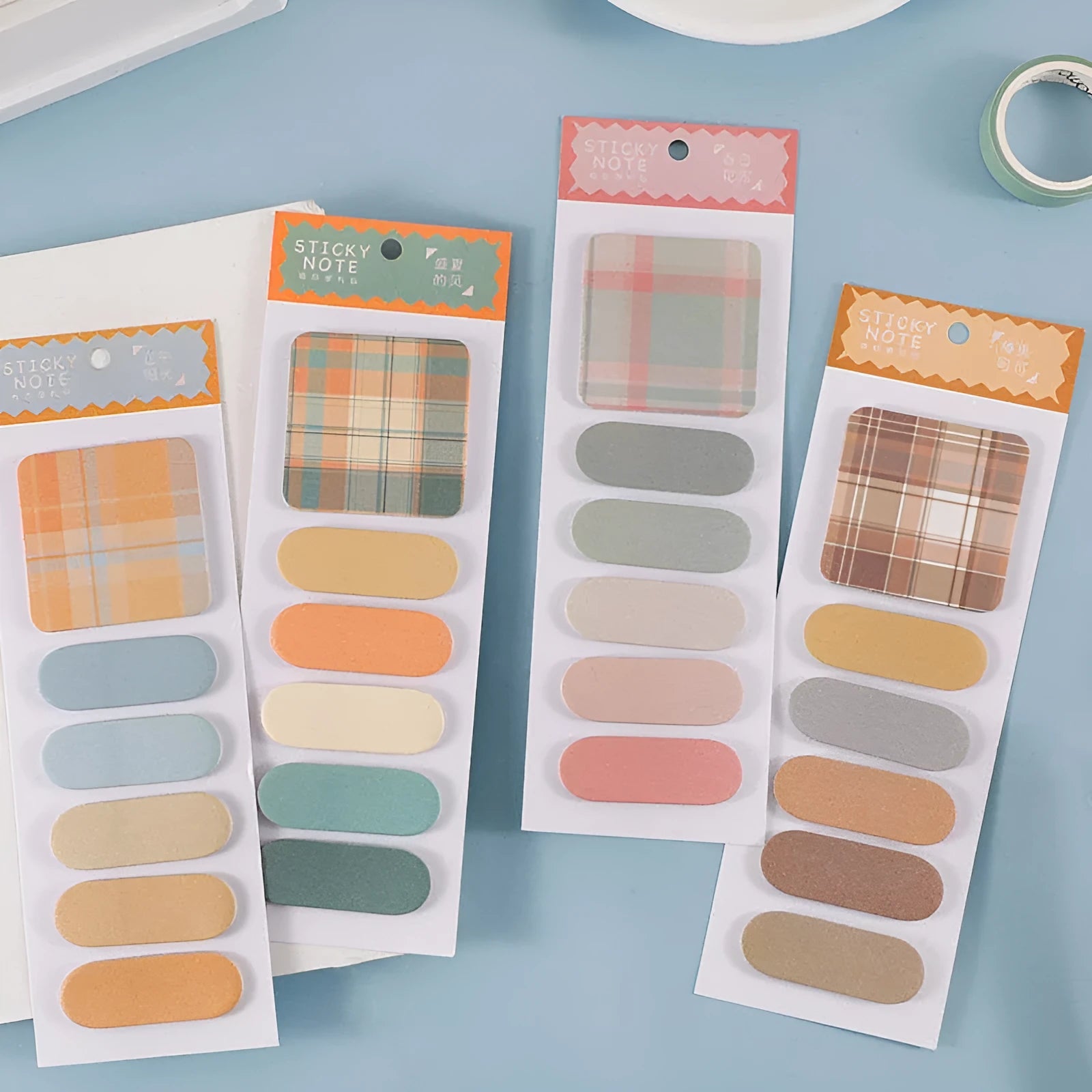 Colourful sticky notes memo pad showing six different designs with plaid and solid colours
