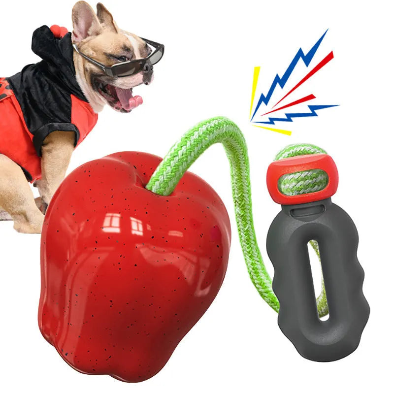 Plastic apple-shaped dog toy with food-dispensing hole and squeaker in green colour