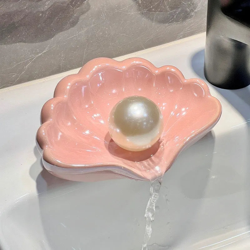 Plastic shell-shaped soap dish in pearl white or cherry blossom pink for bathroom organisation