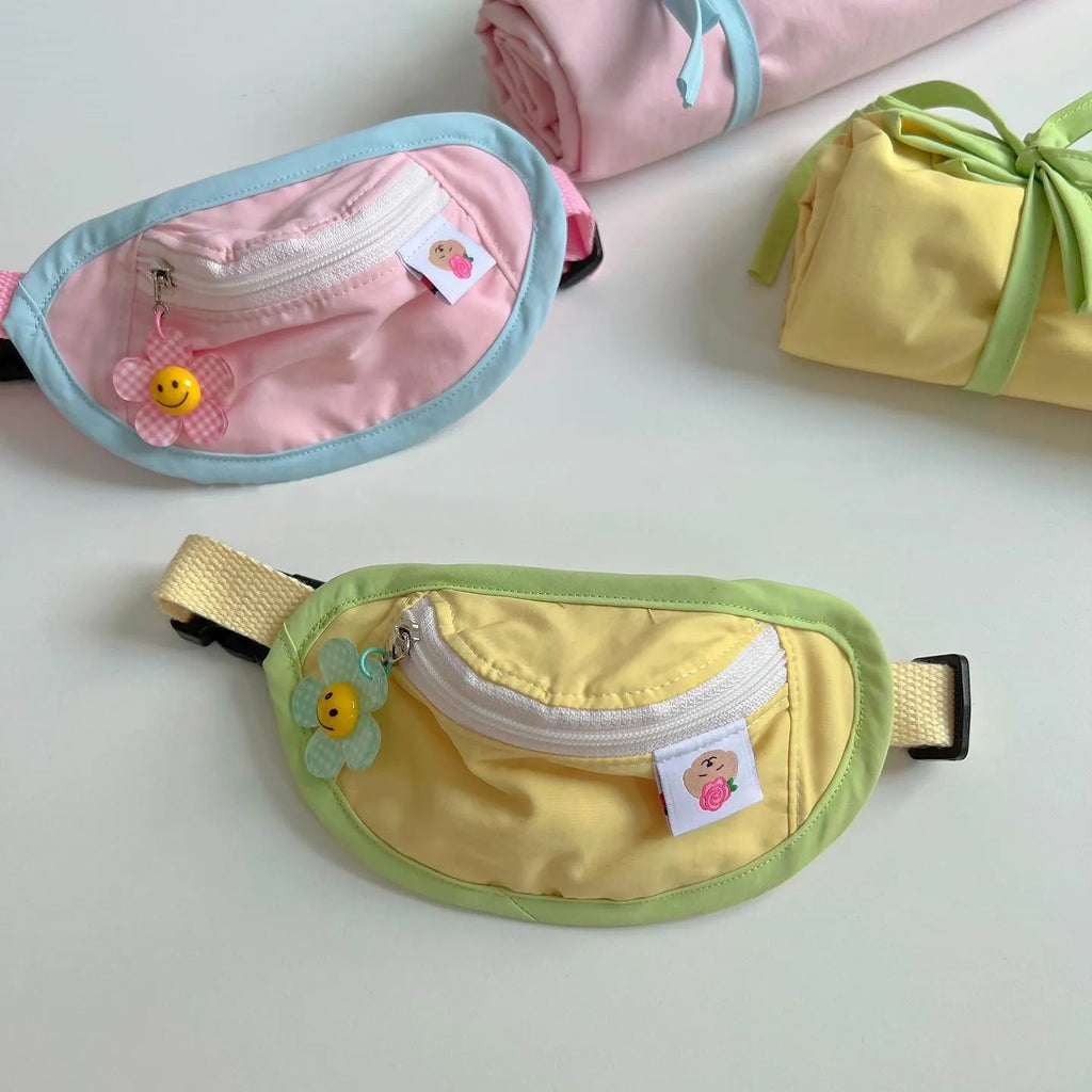 Pink and yellow backpack-style carrier for small dogs or cats, showing mesh panels and a poop bag holder.
