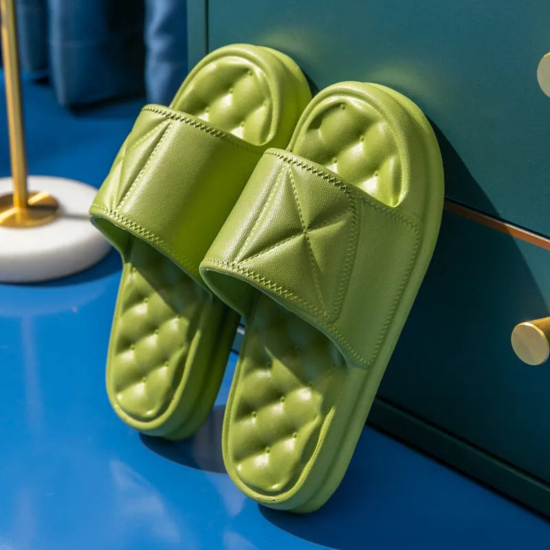 A pair of thick-sole EVA bathroom slippers in a choice of five colours, shown on a bathroom floor.