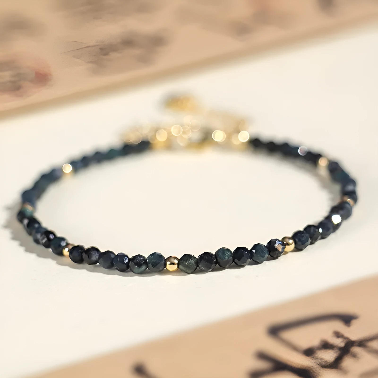 Blue tourmaline 3mm bead bracelet with spacer design on wrist