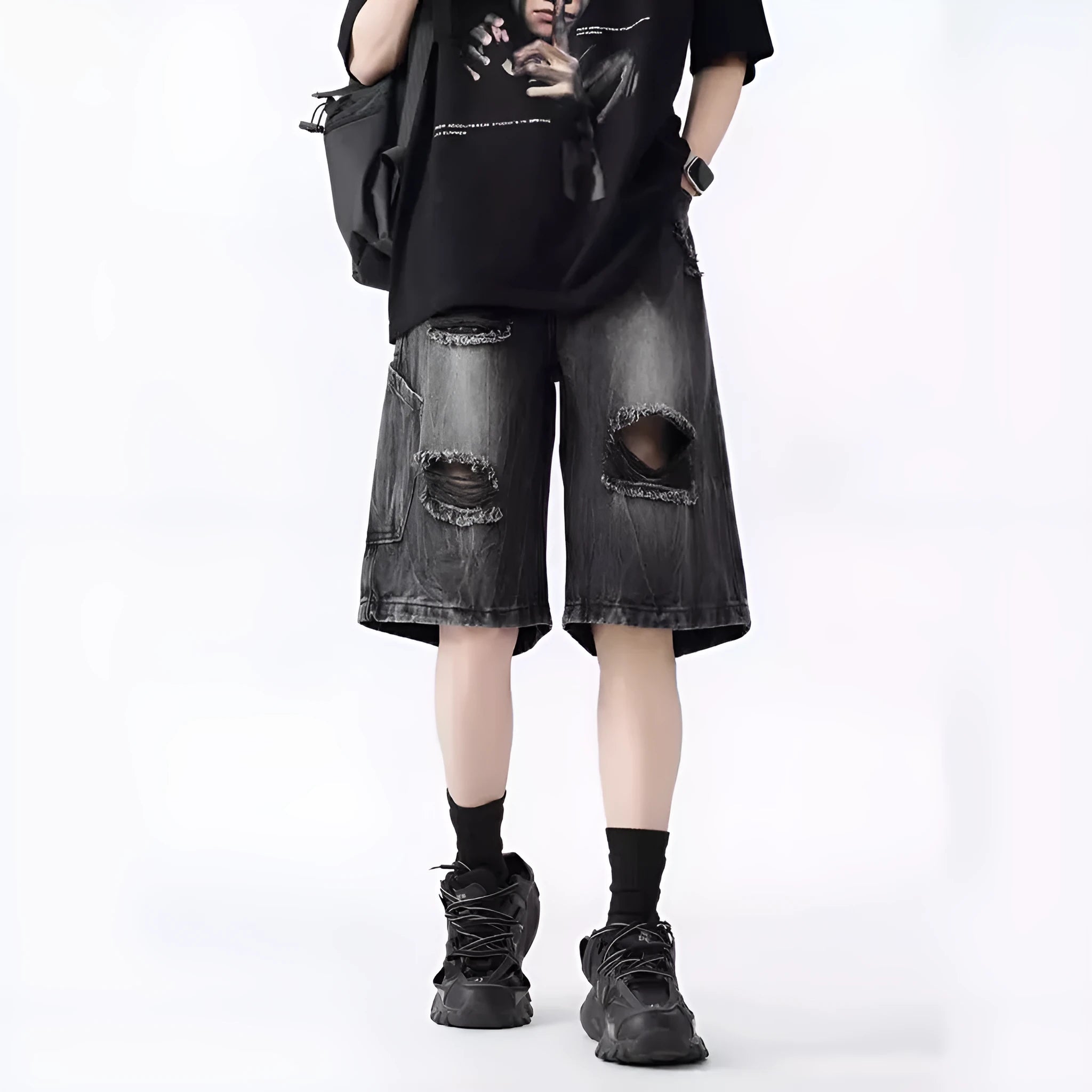 Men's loose fit distressed denim shorts with ripped knee detailing in retro style