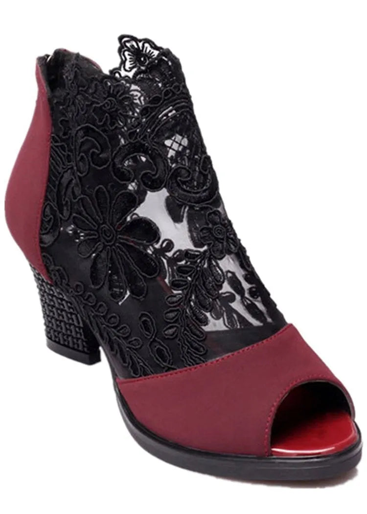 Women's black lace gladiator sandals with square heels and zip closure showing flower detailing