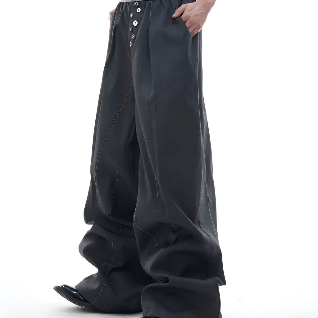 Drooping straight suit pants in black and grey colours showing high waist and button open line design detail.