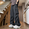 Woman wearing black waterproof plus size straight-leg trousers with a loose fit and drawstring waist.