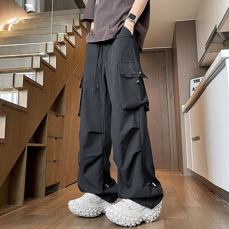 Woman wearing black waterproof plus size straight-leg trousers with a loose fit and drawstring waist.