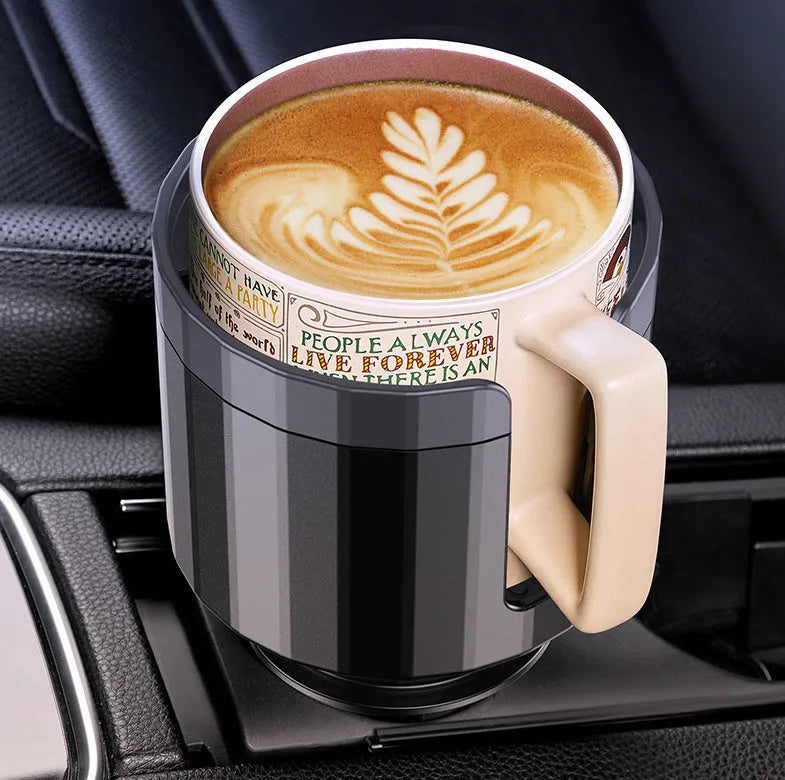 Matte black adjustable car cup holder expander for large bottles and cups on a car centre console.