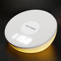 White QI wireless phone charger with digital clock display and three control buttons.