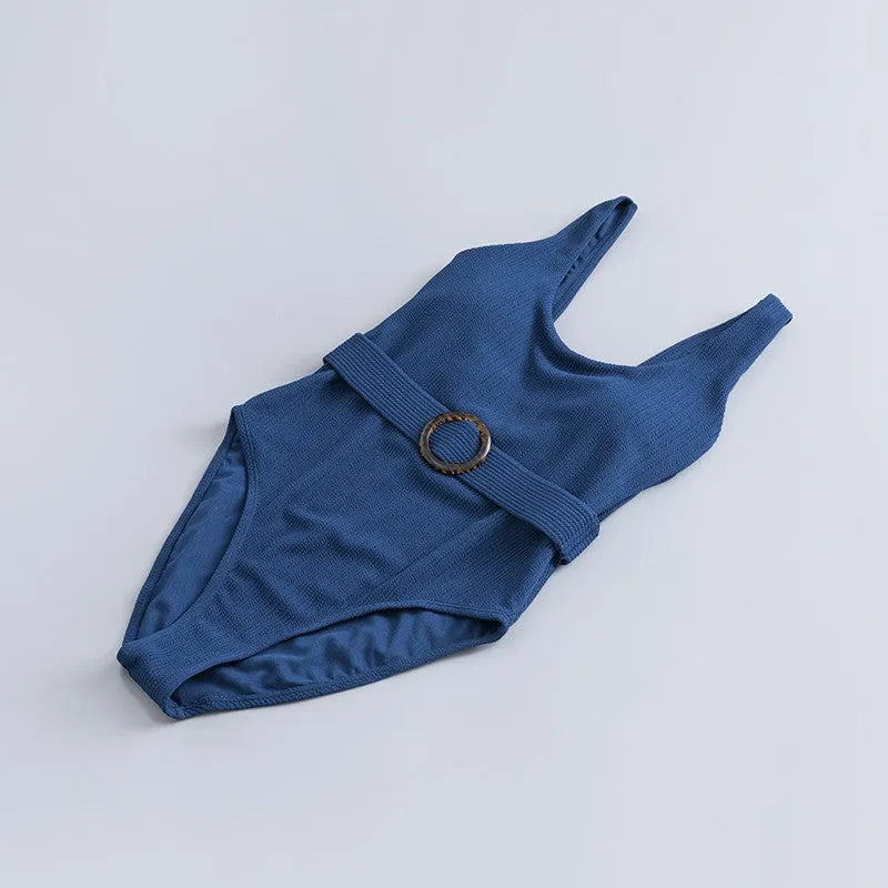 Navy blue one-piece women's swimsuit with triangle design and chest pads on a mannequin