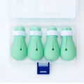 Four green silicone cat paw scratch protection covers for pet grooming.