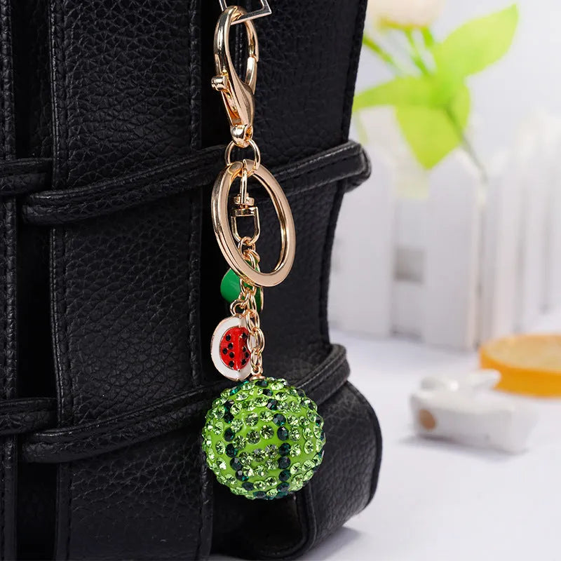Green watermelon-shaped zinc alloy keychain measuring 12cm with metal construction