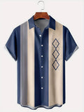 Man wearing a loose fit plaid short sleeve shirt with a lapel collar in a casual setting.