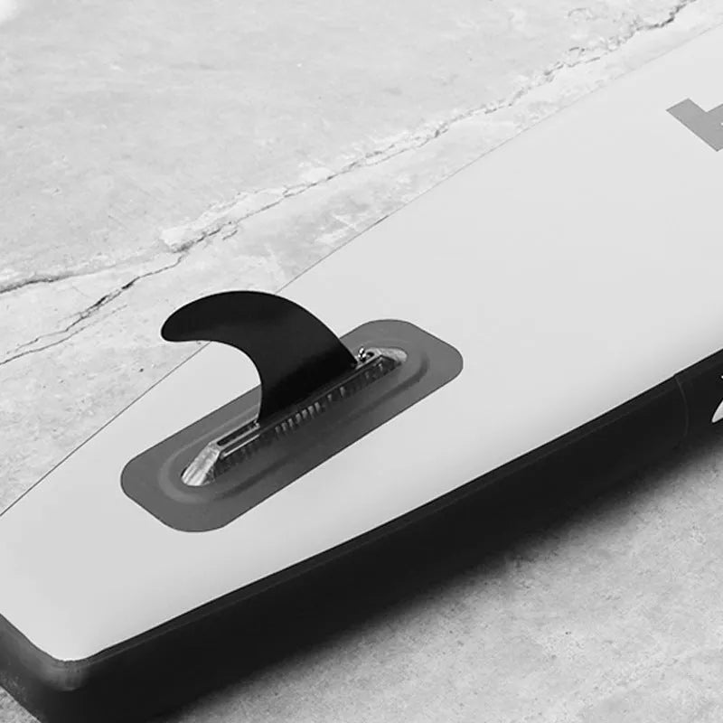 SUP paddle with large removable plastic fish fins showing screw attachment system
