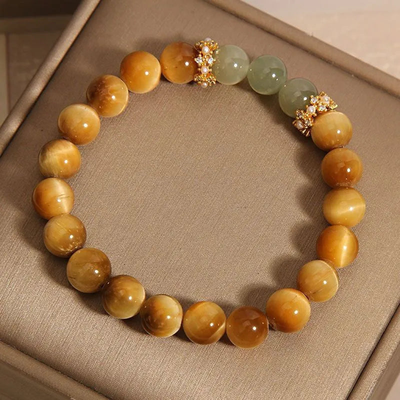 Natural yellow tiger's eye Hetian jade bracelet in u-shaped design with auspicious patterns.