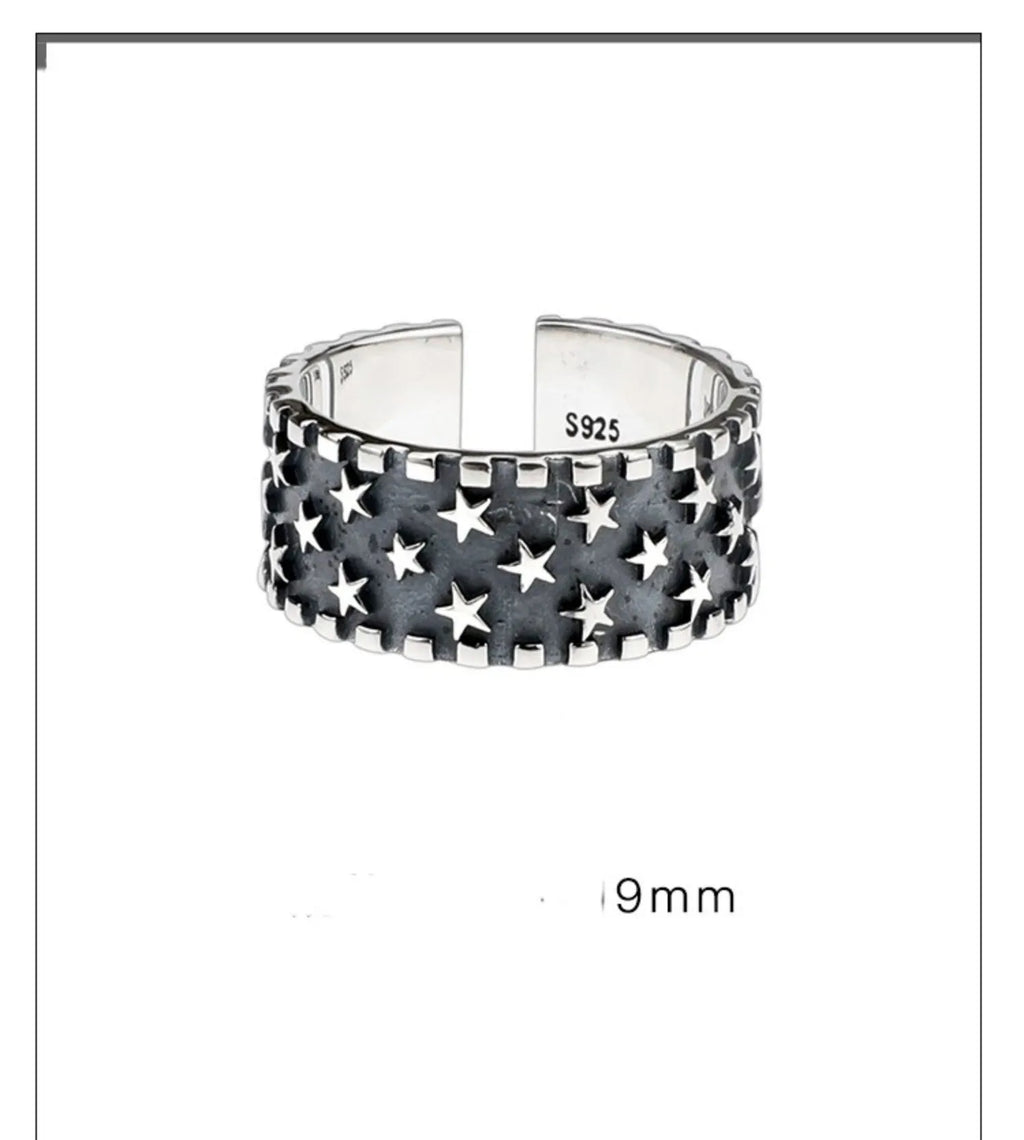 Silver adjustable ring with geometric five pointed star pattern on finger