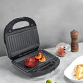 Black electric sandwich pan with double-sided heating, brushed stainless steel lid, and six non-stick cooking plates.