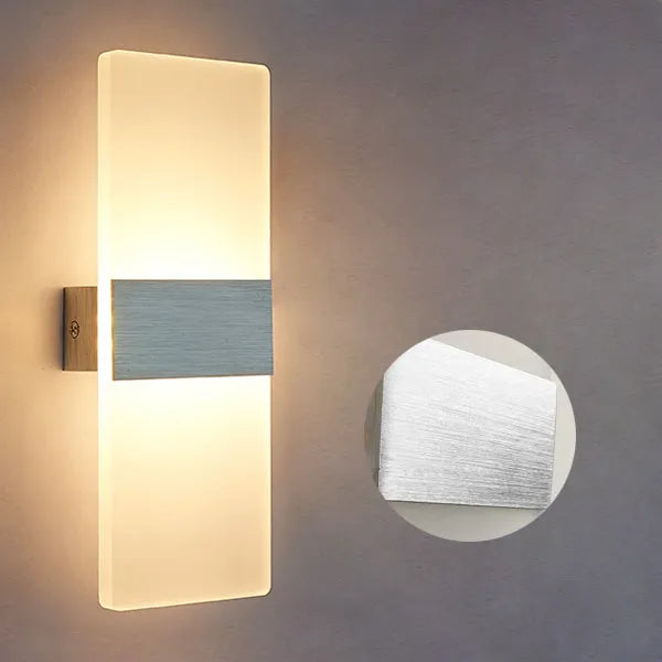 Modern acrylic LED wall lamp in black finish mounted on a corridor wall measuring 27x10cm