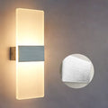 Modern acrylic LED wall lamp in black finish mounted on a corridor wall measuring 27x10cm
