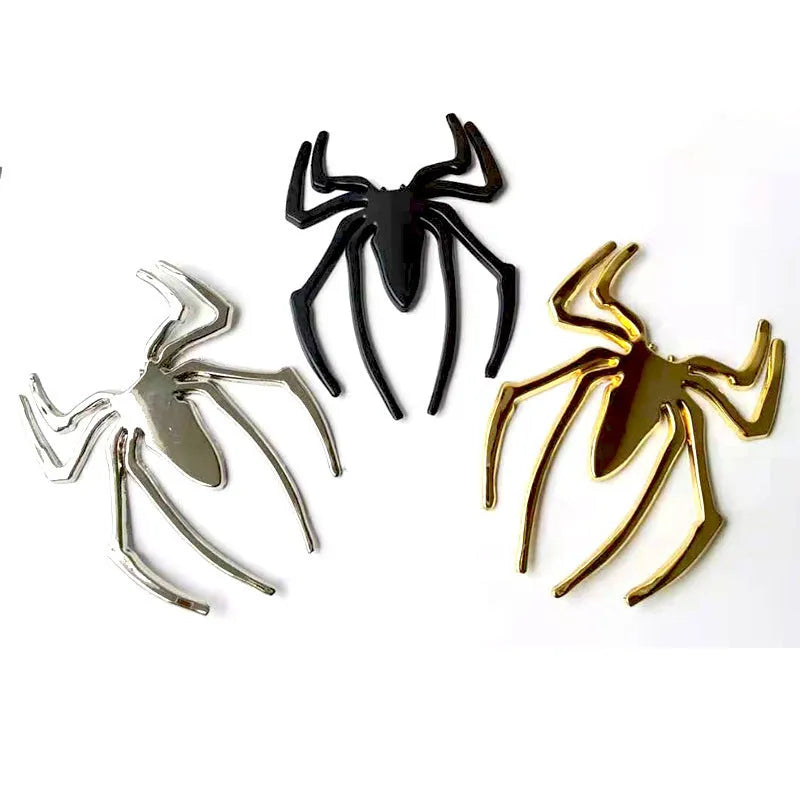 Three-dimensional metal spider bumper sticker in zinc alloy on a car bumper.